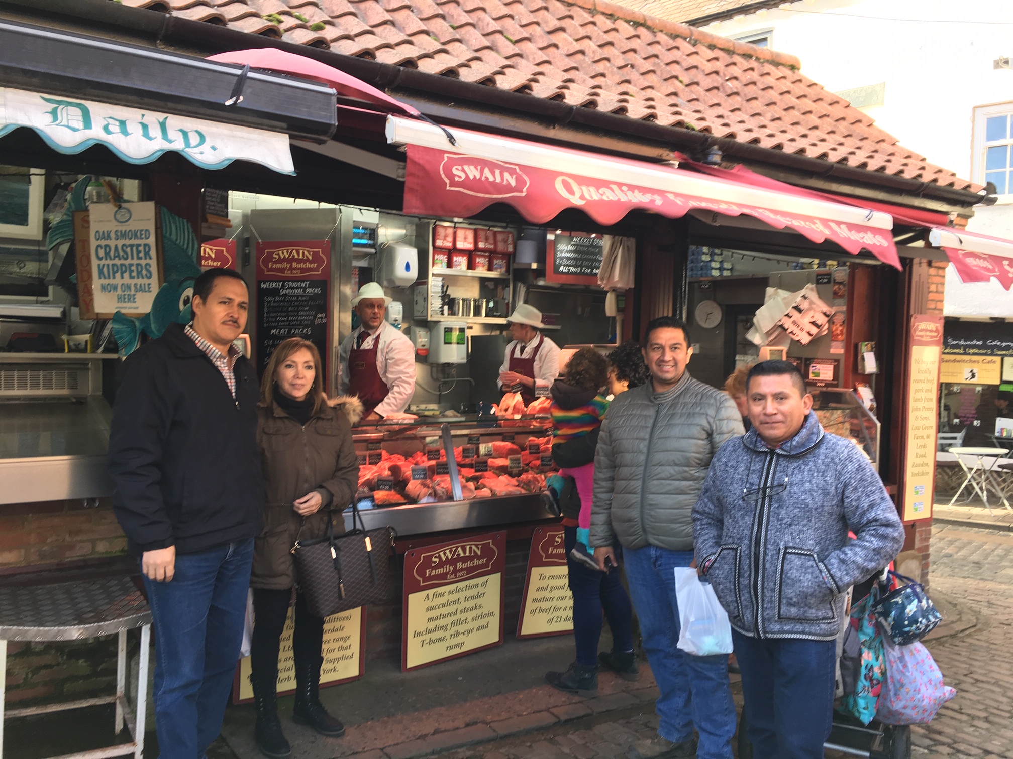 a group of people standing outside a market